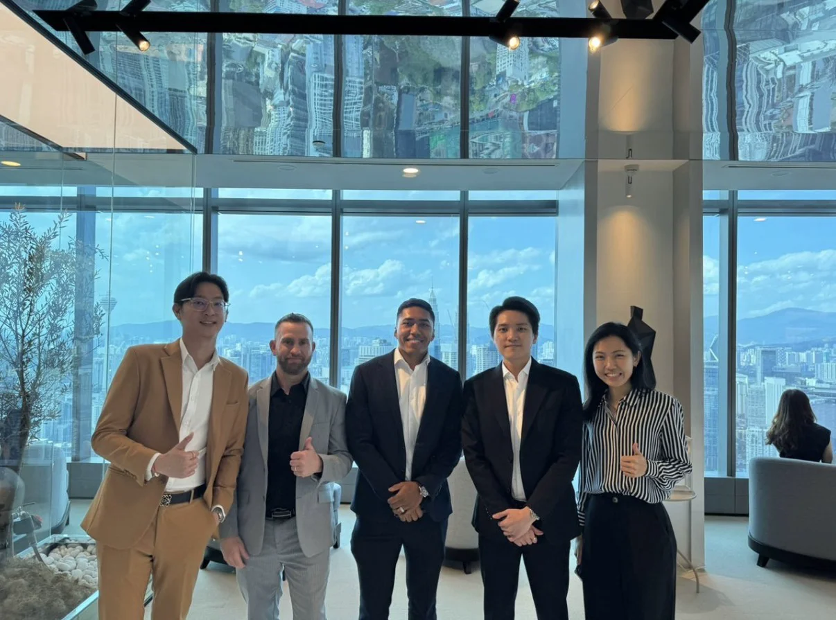 Oscar Munoz and William Thomas with the Crewstone International leadership team — Shien, Keng Fai (CEO), and Doris — at Crewstone's headquarters in Kuala Lumpur, Malaysia